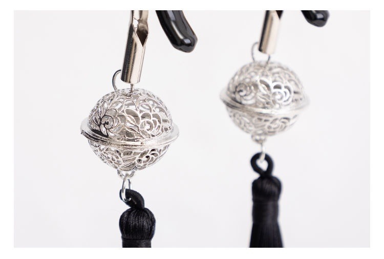 Black tassel clip pair: close-up of the filigree balls, connecting rings and tassel knots.