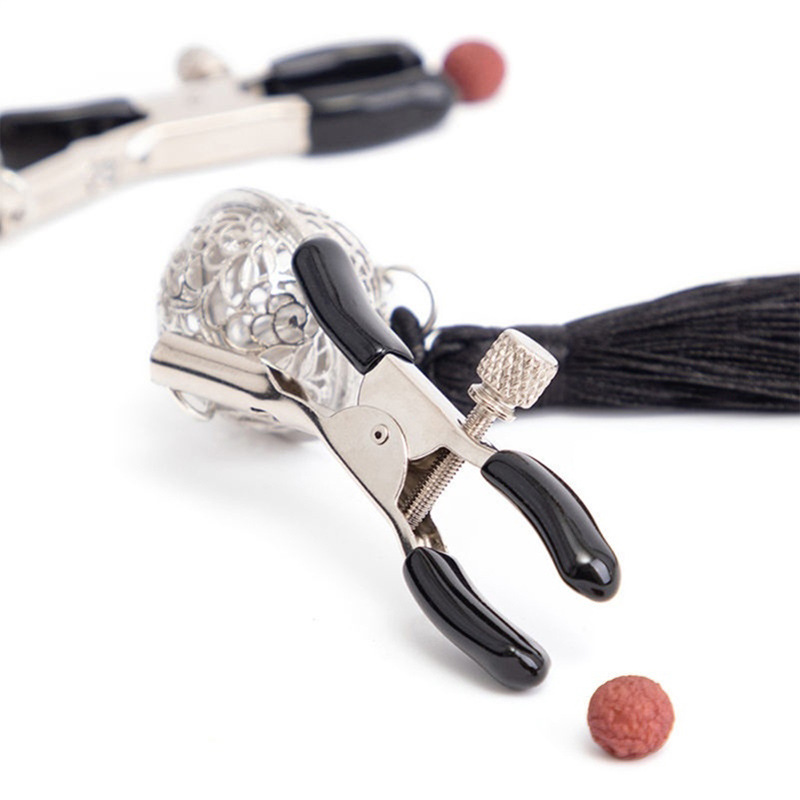 Black tassel clip pair: adjustment screw, padded jaws and filigree-ball connection.