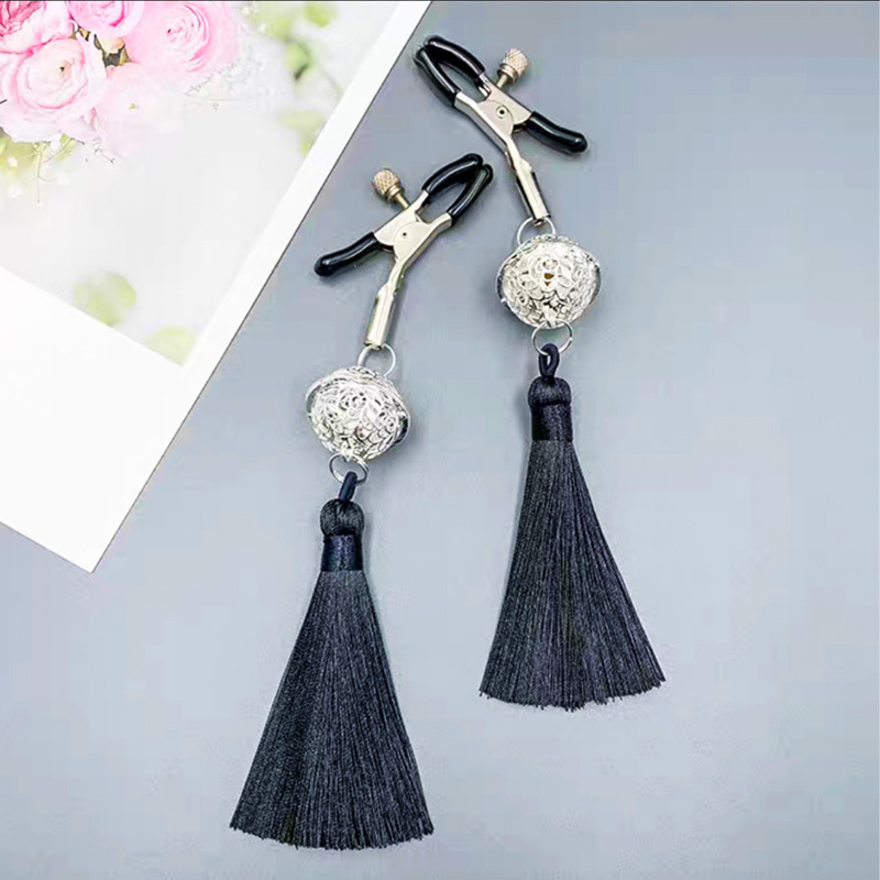 Black tassel clip pair: supplier product-only display on a gray surface.